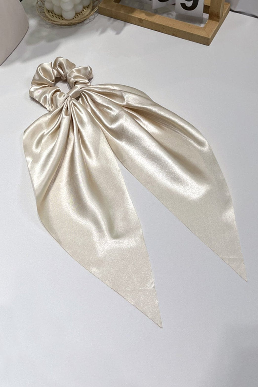 Bandeau satiné à nœud élégant champagne harmonie