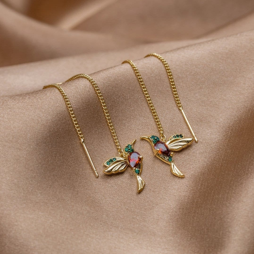 Boucles d'oreilles colibri dorées détail ailes liberté