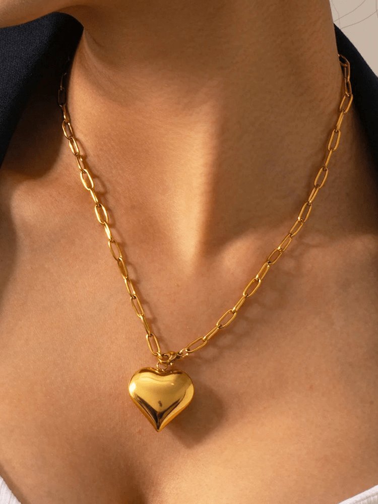 Collier trombone doré avec pendentif cœur étincelant