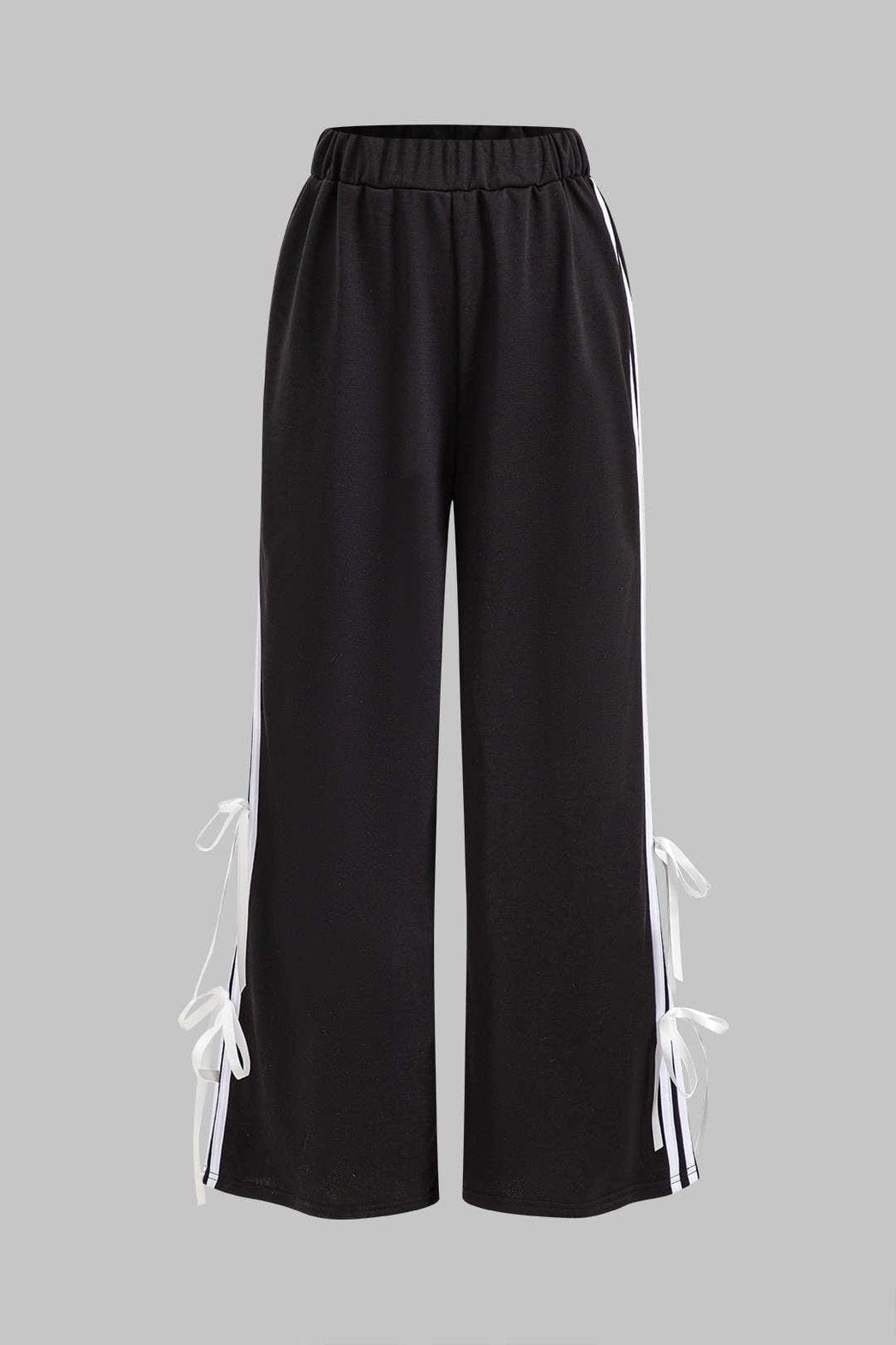 Détail nœuds décoratifs sur ensemble noir étincelant