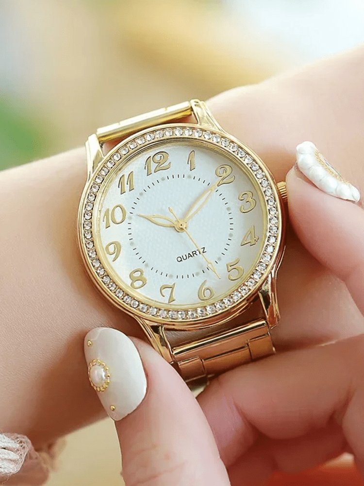 Montre élégante dorée avec cristaux brillants soleil