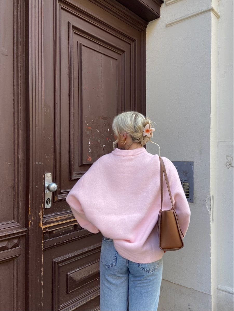 Détail couture pull rose qualité paix