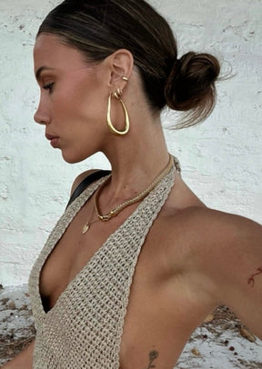 Boucles d'oreilles dorées profil élégant soleil