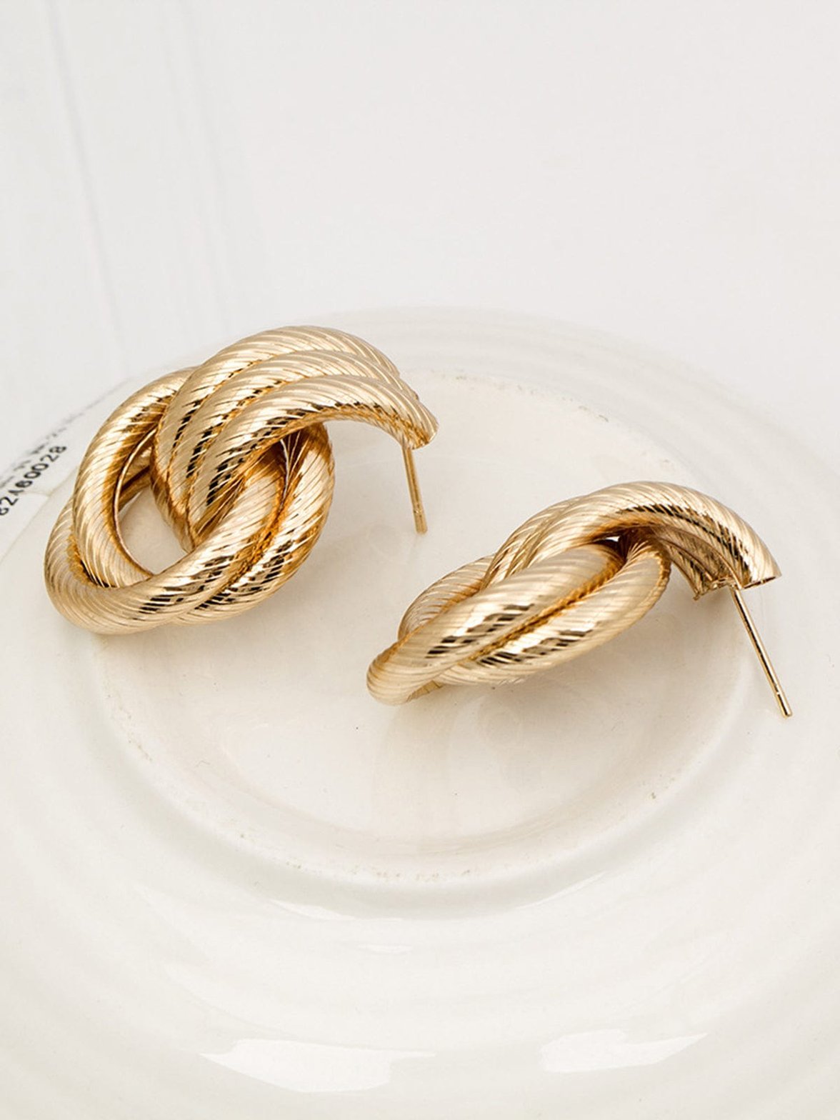 Boucles d'oreilles torsadées dorées vue frontale saphir