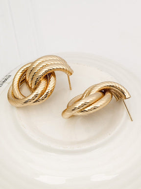 Boucles d'oreilles torsadées dorées vue frontale saphir