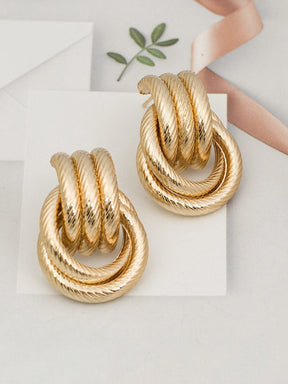 Boucles d'oreilles torsadées dorées vue latérale cristal