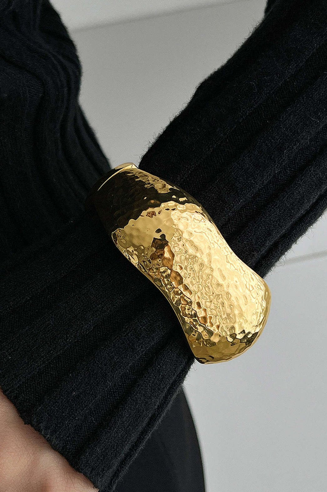 Bracelet géométrique doré porté sur poignet élégant butterfly
