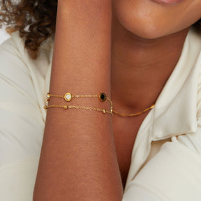 Bracelet plaqué or avec pierres noires et blanches harmonie