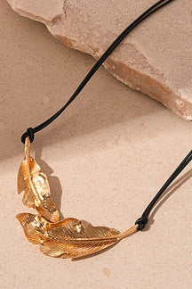 Détail pendentif feuille dorée métallique vent
