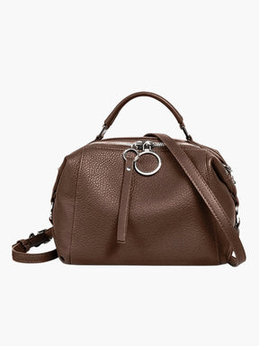Sac en cuir bleu porté épaule arc