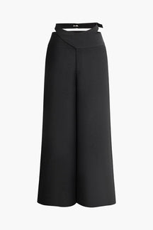 Pantalon large noir élégant avec boucle décorative soleil
