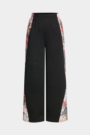Pantalon palazzo noir à motifs floraux vue face soleil