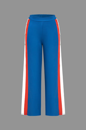Pantalon sport bleu avec bandes latérales rouge et blanc soleil