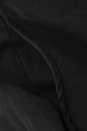 Pantalon élégant noir drapé lumière