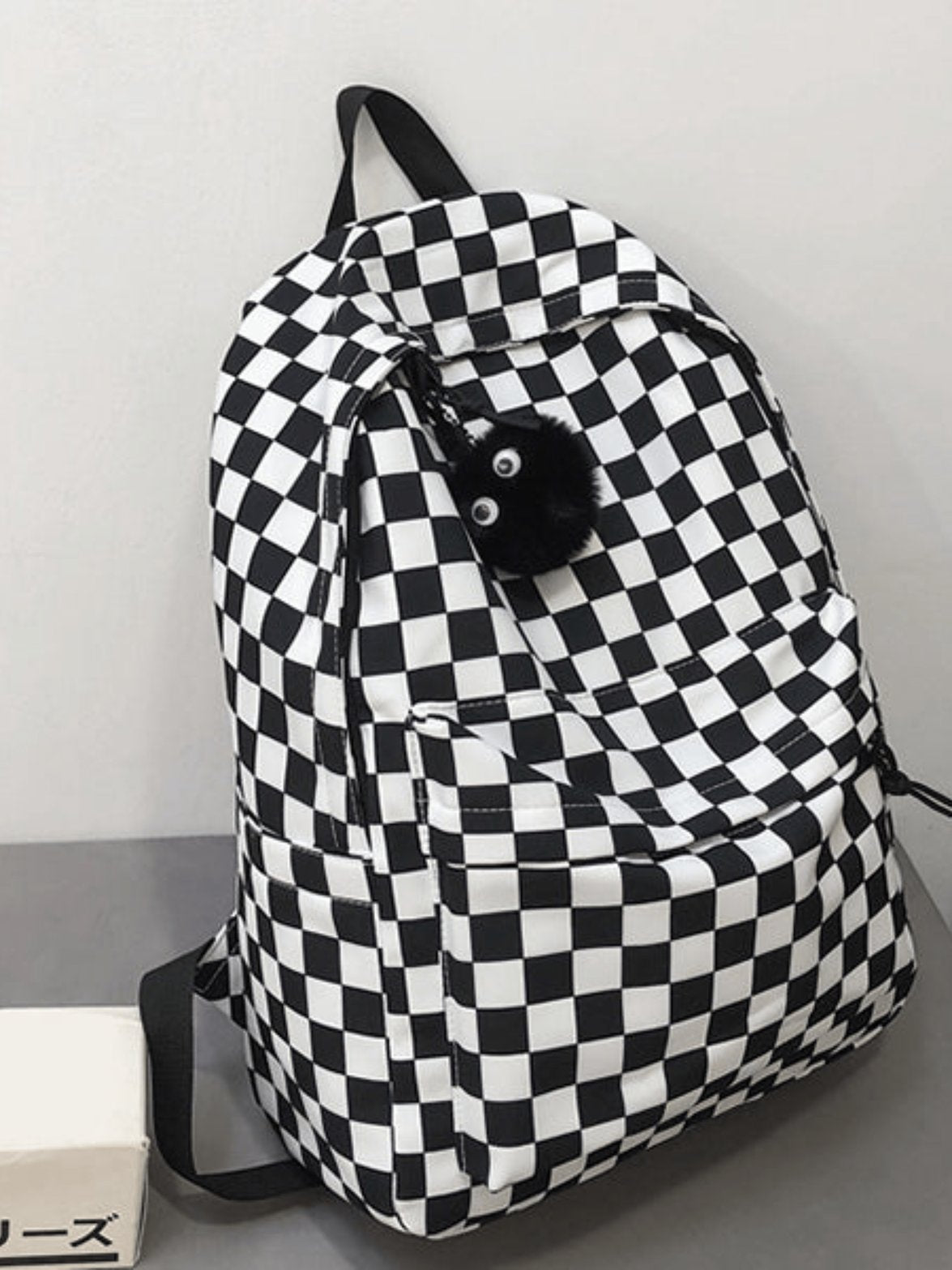 Sac à dos damier porté dos pluie