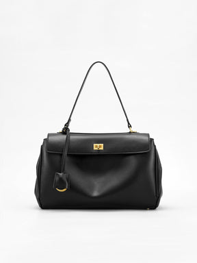Sac à main noir élégant en cuir synthétique vue avant soleil