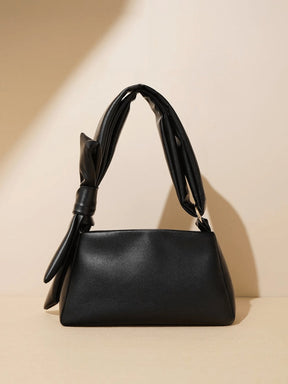 Sac à main en cuir marron porté épaule étoile