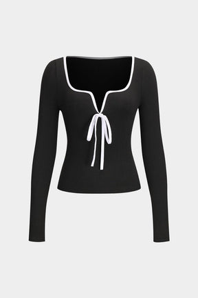 Top noir élégant avec nœud blanc décoratif papillon