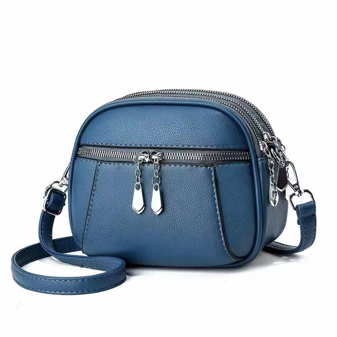 Sac bandoulière cuir bleu jolieandjuliette compact multipoches zips argentés élégant