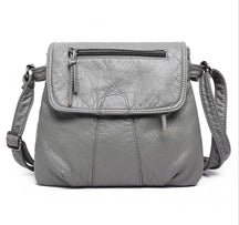 Sac bandoulière cuir gris jolieandjuliette texture grainée zip frontal élégant