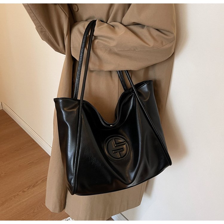 Sac tote cuir noir jolieandjuliette élégant avec logo circulaire en relief