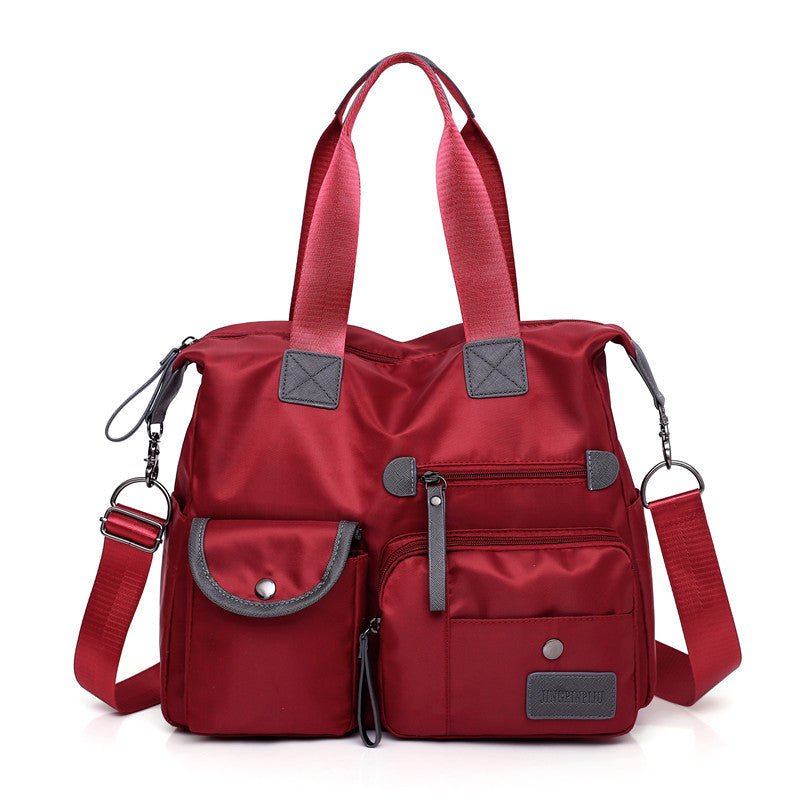 Sac fourre-tout rouge jolieandjuliette en nylon avec multiples poches et bandoulière ajustable