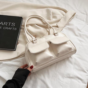 Sac à main blanc crème élégant jolieandjuliette avec poches avant sur fond textile