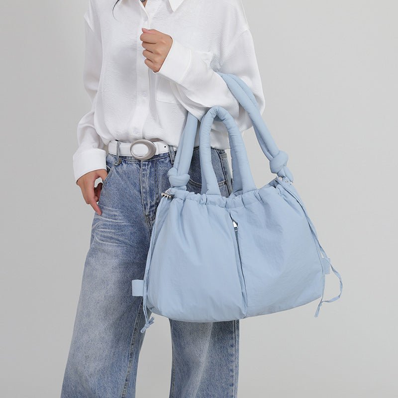 Sac à main bleu ciel jolieandjuliette porté avec chemise blanche et jean décontracté