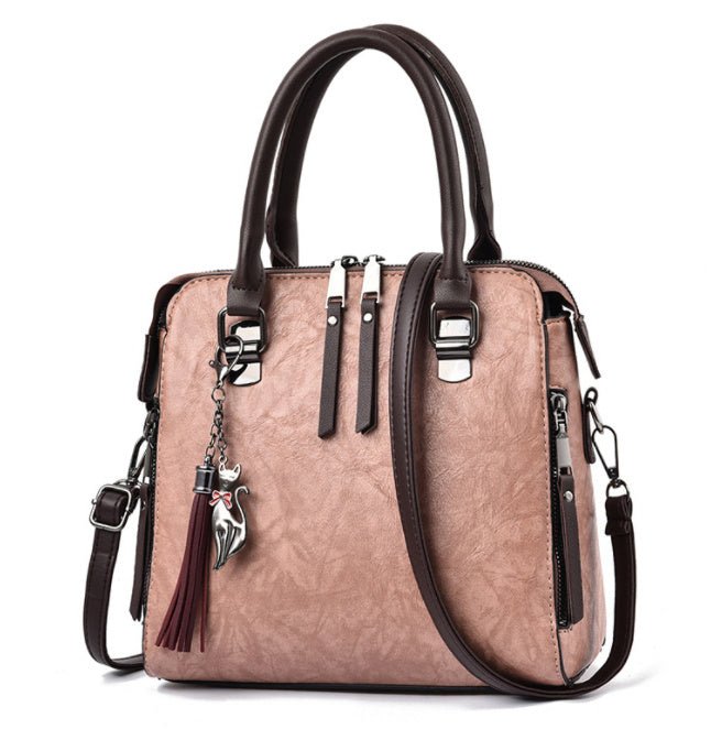 Sac à main jolieandjuliette en cuir rose et marron avec bandoulière amovible et charm gland