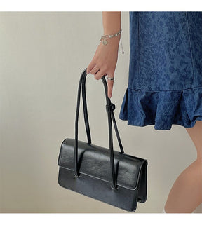 Sac à main noir élégant jolieandjuliette avec poignée fine et design minimaliste