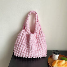 Sac à main rose texturé jolieandjuliette à pompons épaule féminin élégant