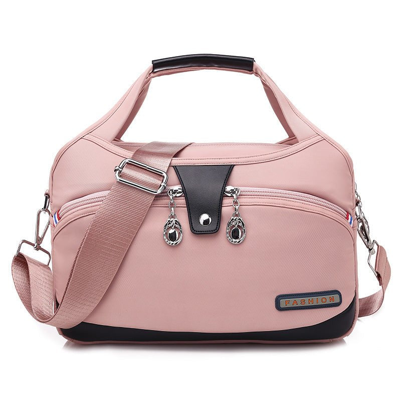 Sac de voyage rose poudré jolieandjuliette multifonction avec bandoulière et multiples zips